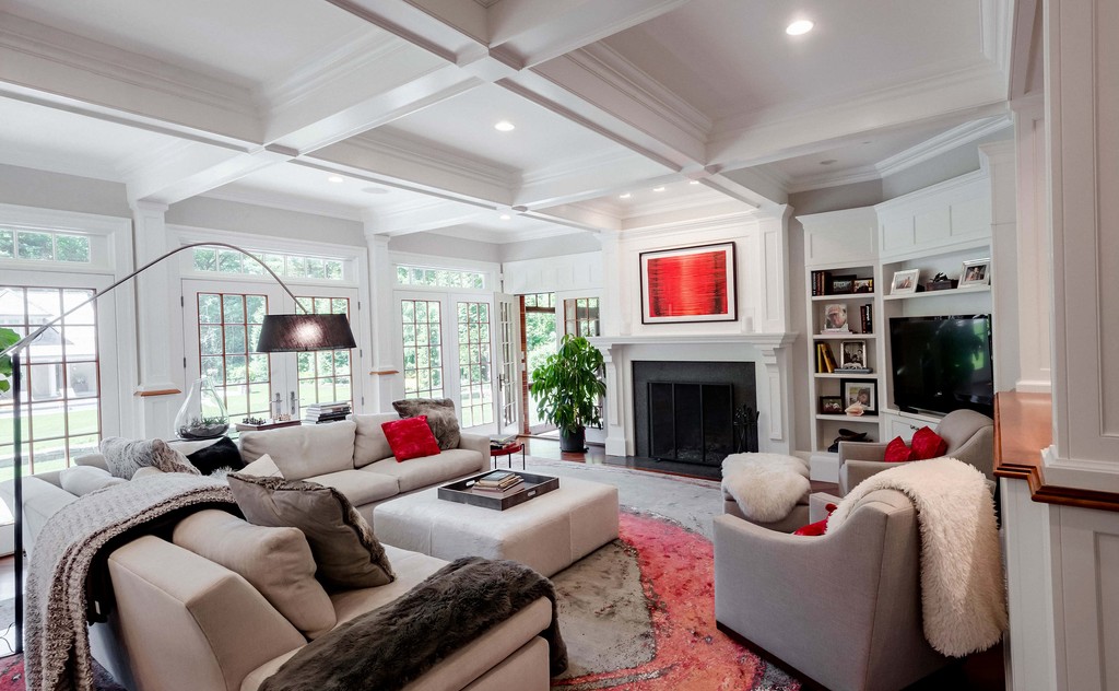 Spacious family room with coffered ceiling and built-ins