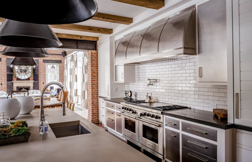Gourmet kitchen with industrial range and exposed beams