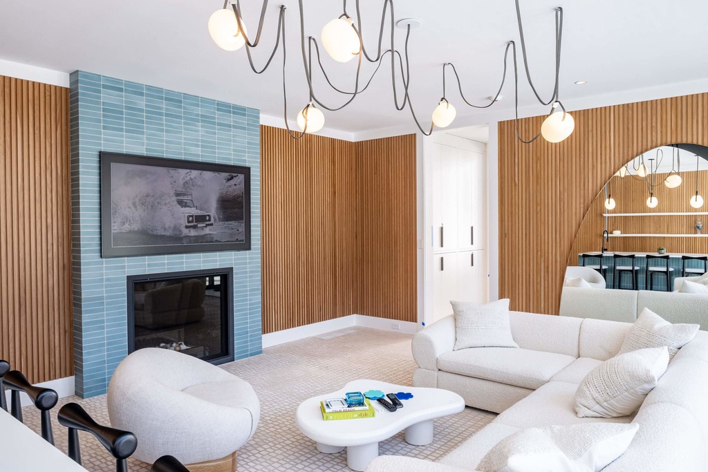 Pool house modern fireplace wall with sculptural lighting and art