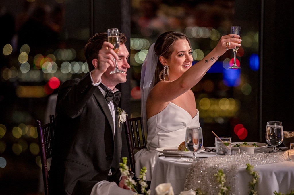 Bride and groom raise their glasses to a toast