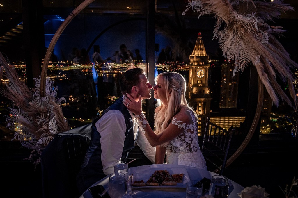 Intimate sweetheart table moment with night city view