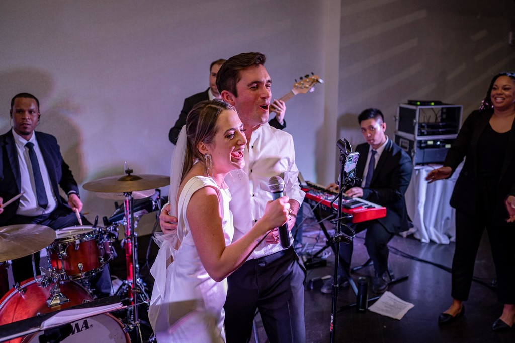 Wedding couple joins the live band Boston wedding reception