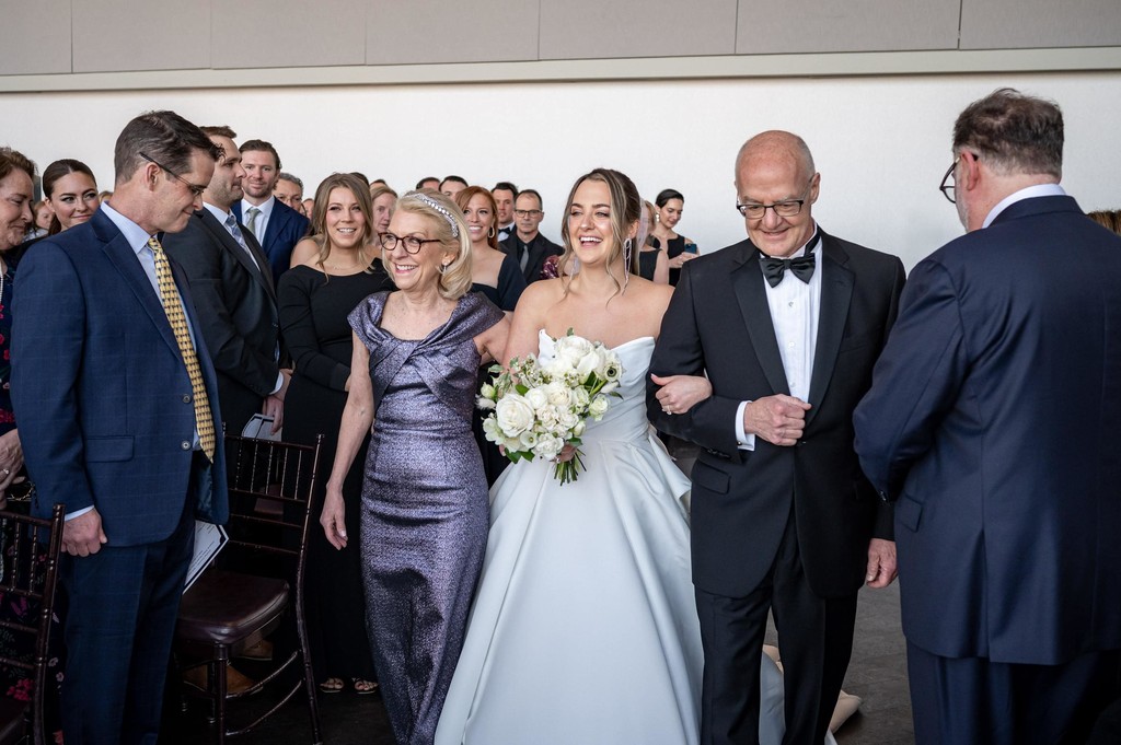 Bride walking down the aisle with her parents