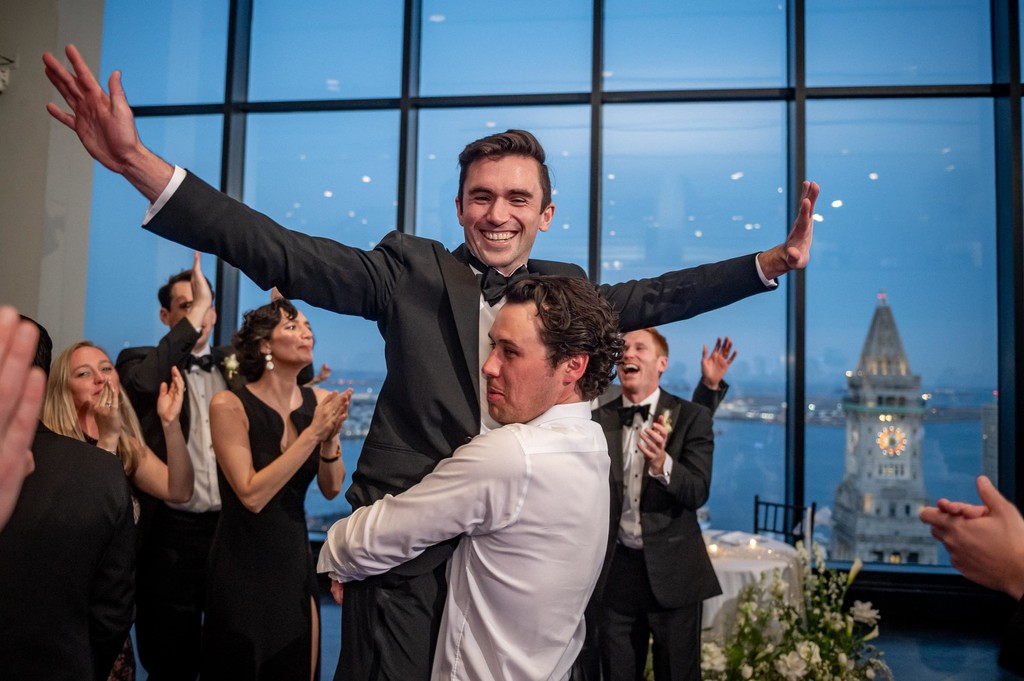 Friend lifting the groom at the wedding reception