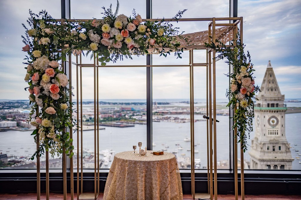 Wedding ceremony floral arch and skyline view