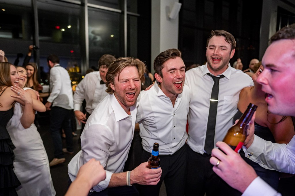 Groom celebrating with friends on the dancefloor