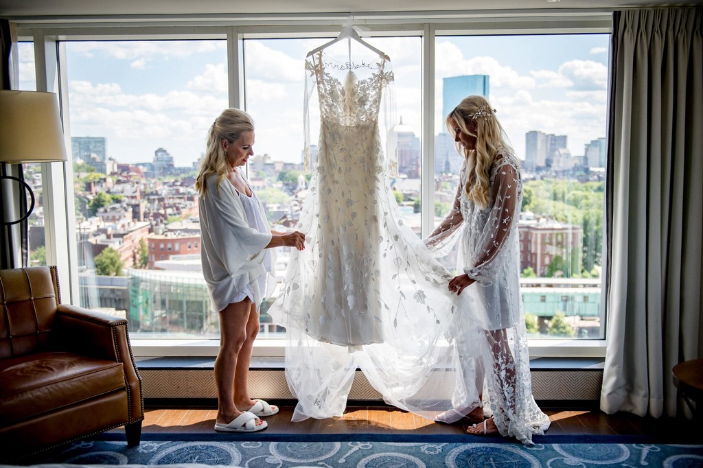 Bride and mom looking at dress before getting ready