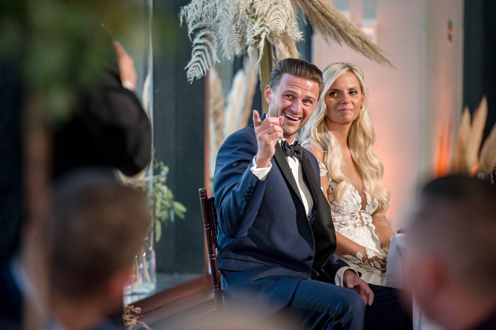 Groom smiling during a wedding speech