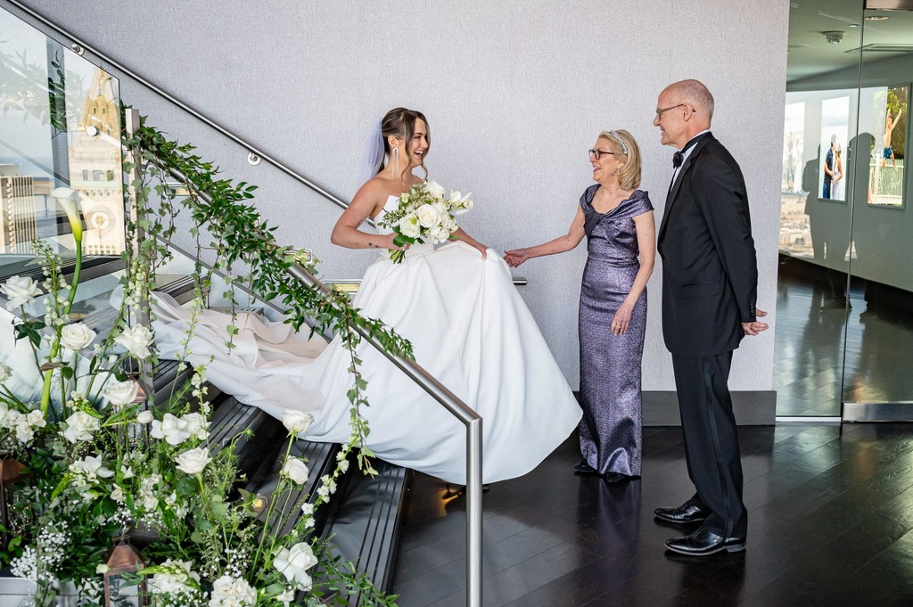 Bride descending staircase to greet her parents