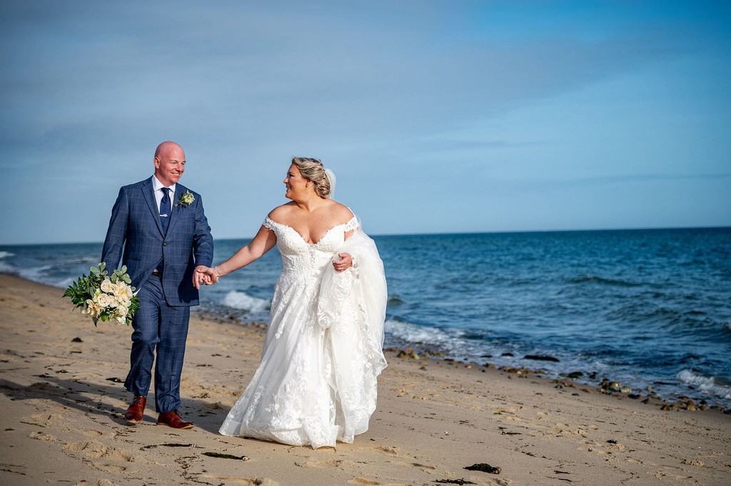 Club at New Seabury wedding couple stroll along the beach