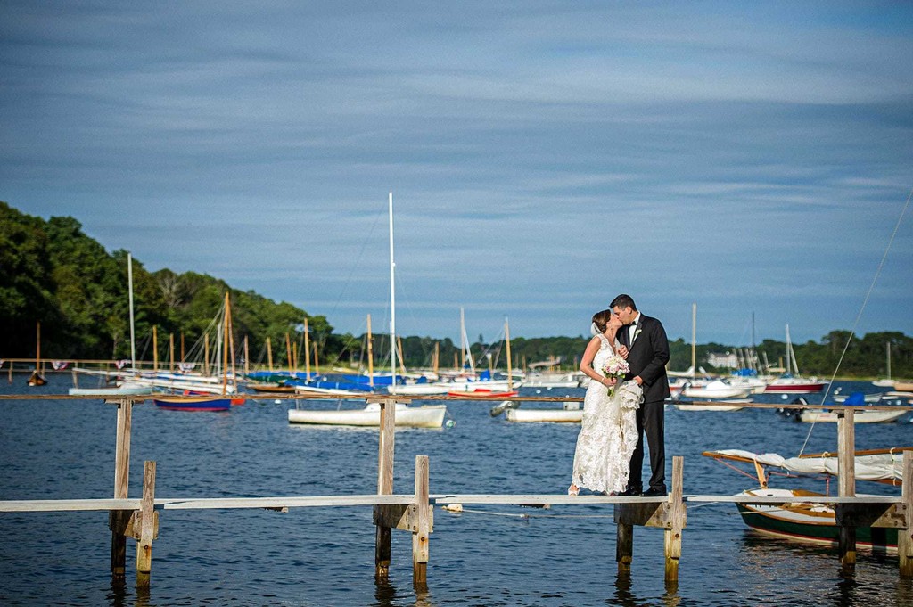 Bride & Groom kiss on a dock in Cotuit
