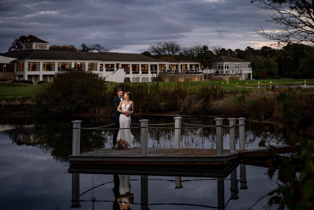 Wedding couple on a dock at Willowbend at dusk