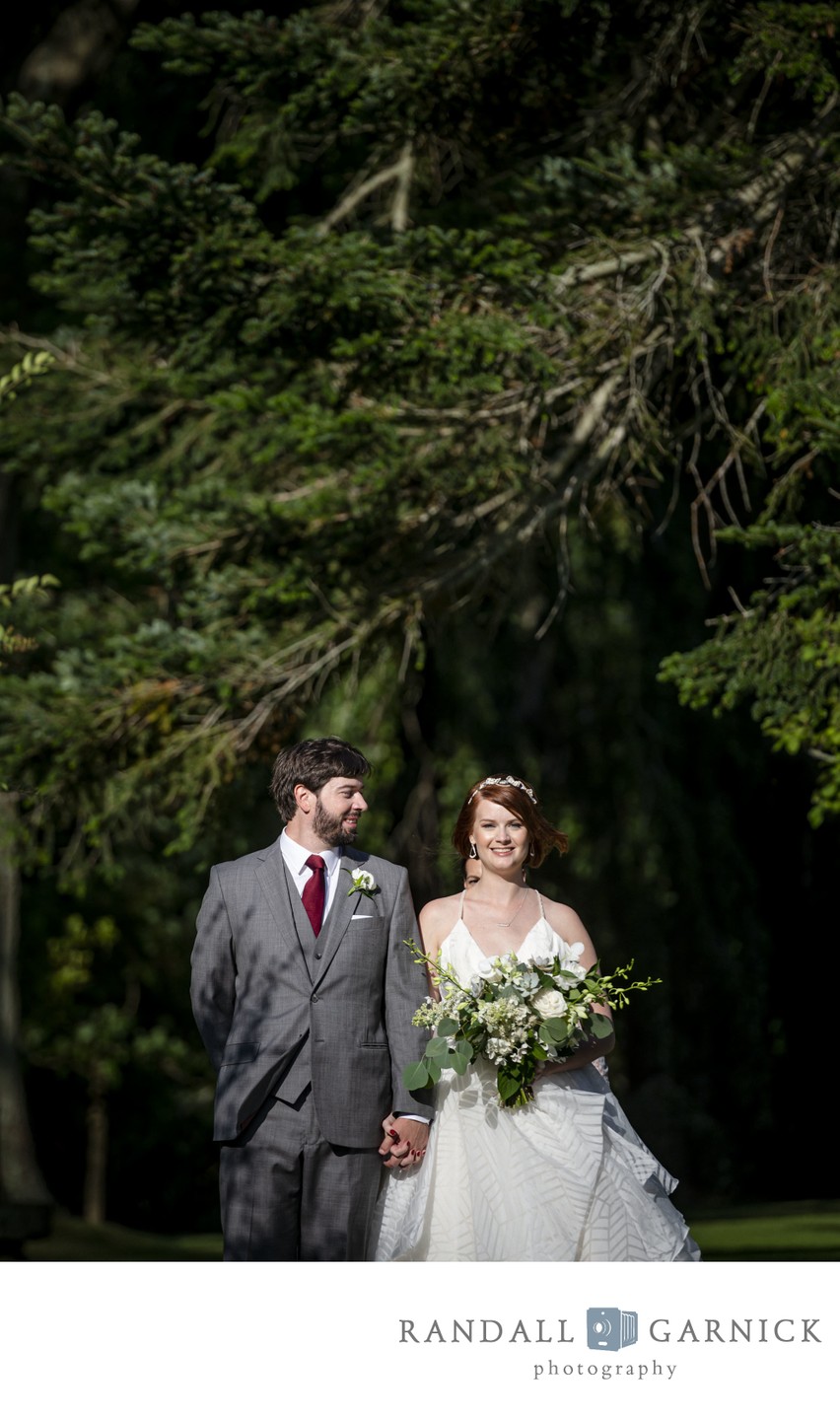 Couple walking to their ceremony at Blithewold Mansion wedding