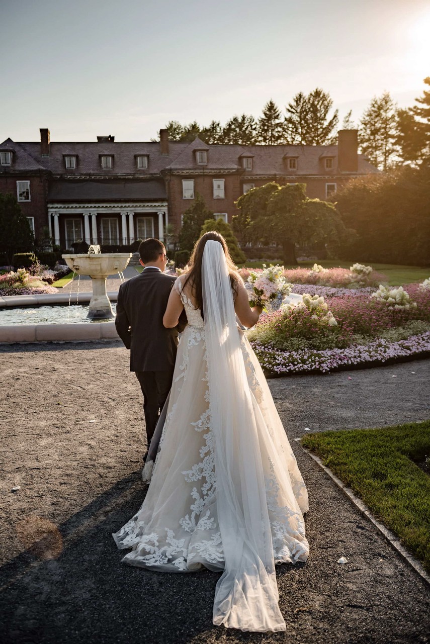 Couple walking towards the sunset at Elm Bank wedding