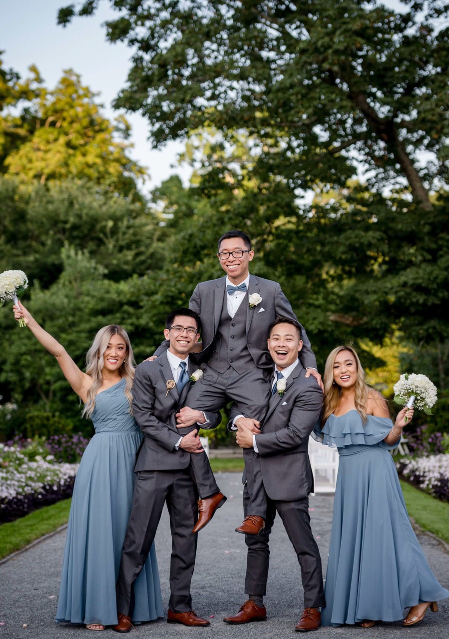 Wedding party laughing together in the gardens at Elm Bank weddings