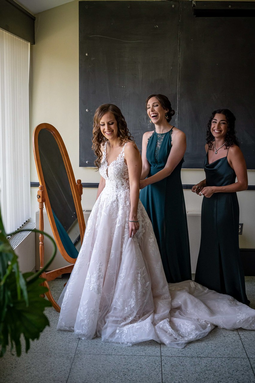 Bride and bridesmaids sharing a special moment before Elm Bank wedding