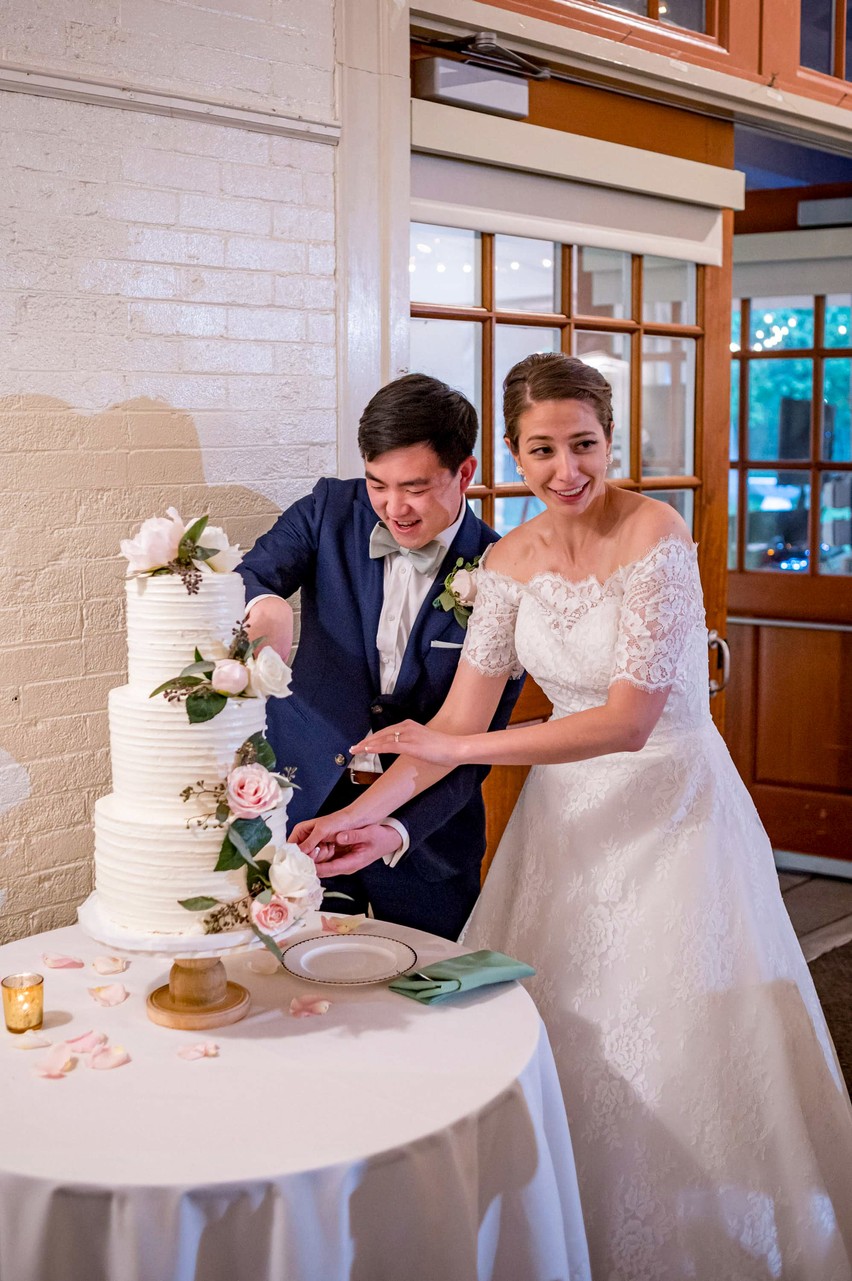 Funny cake cutting moment at an Elm Bank wedding