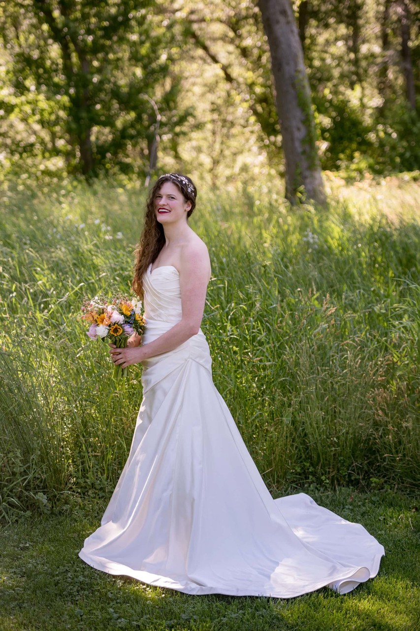 Bride walking through gardens at Long Hill wedding in MA