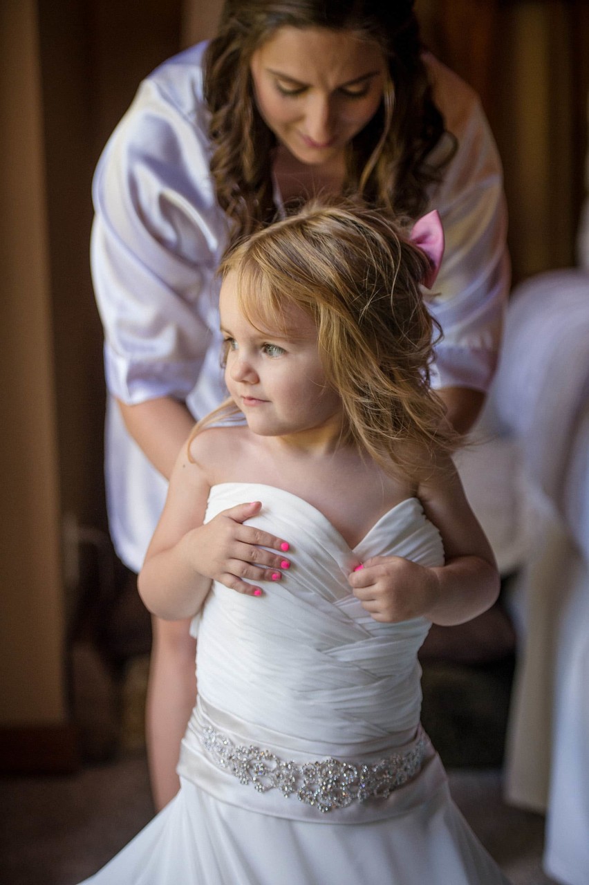 Bride playing dress up with flower girl at Fern Hill Barn