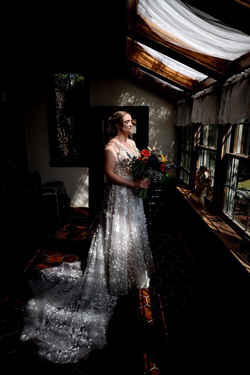 Bride with dramatic light indoors – Fern Hill Barn prep space