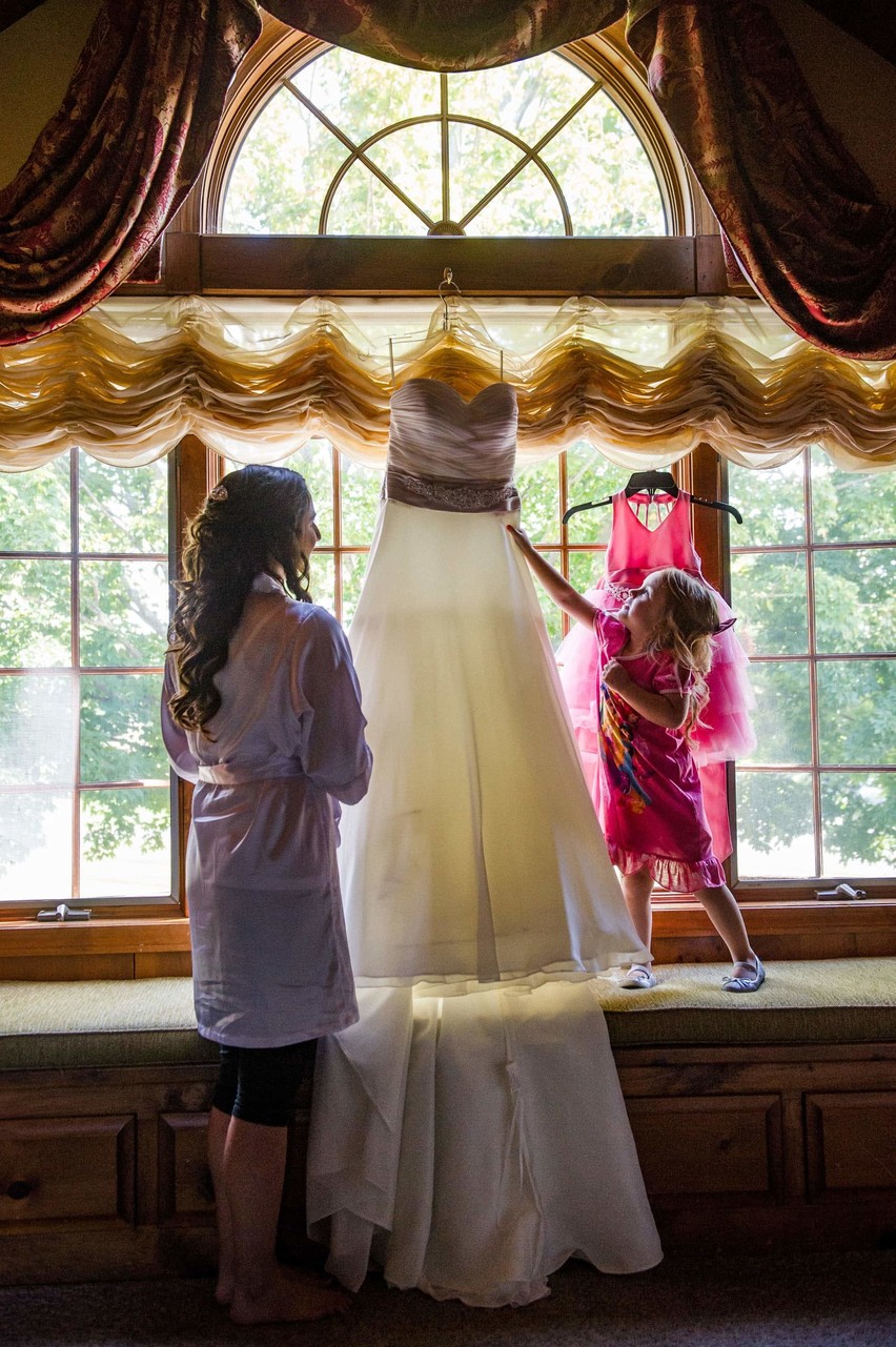 Flower girl inspecting the dress at Fern Hill Barn