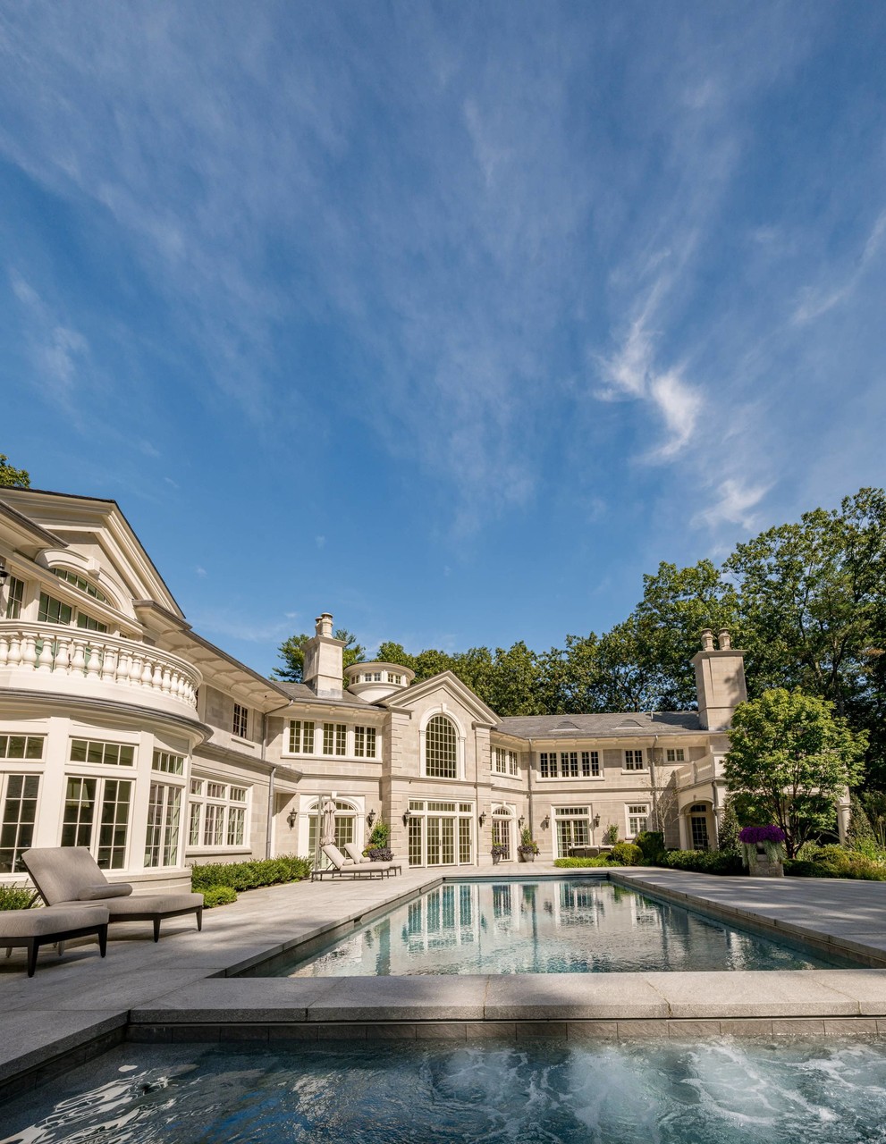 Luxury estate exterior with pool and classical stonework