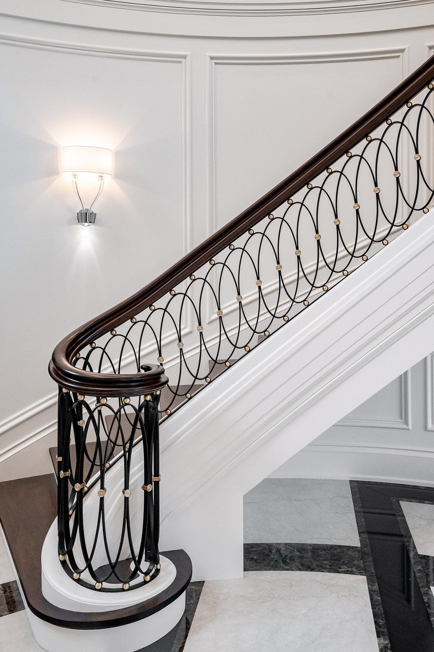 Architectural staircase with detailed custom wrought iron railing
