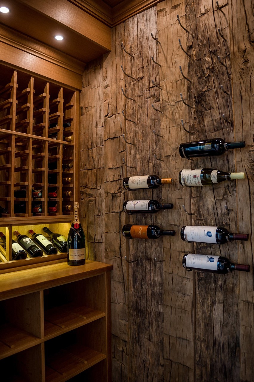 Built-in wine cellar wall with natural wood cabinetry