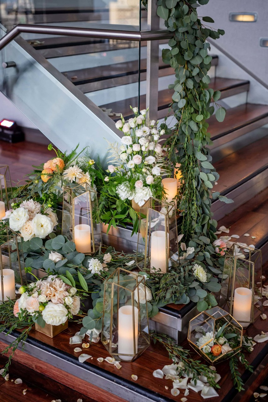 Lush florals and candles on ceremony staircase