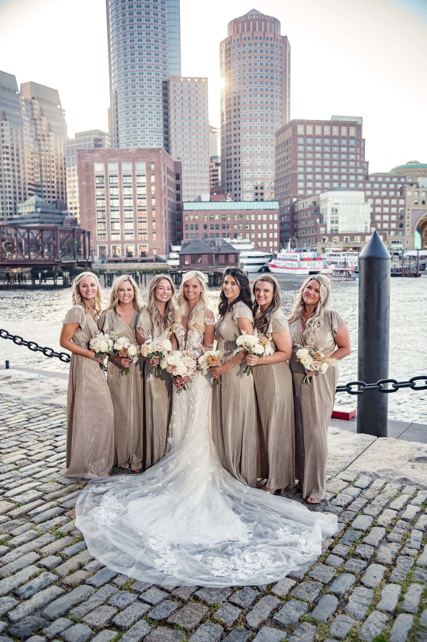 Bridesmaids in champagne dresses with Boston skyline