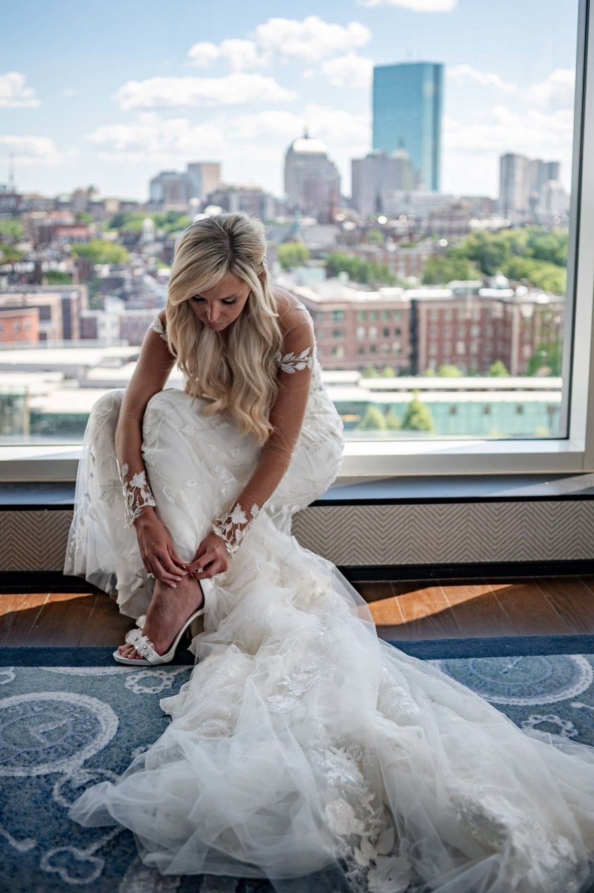 Bride getting ready in suite with Boston views