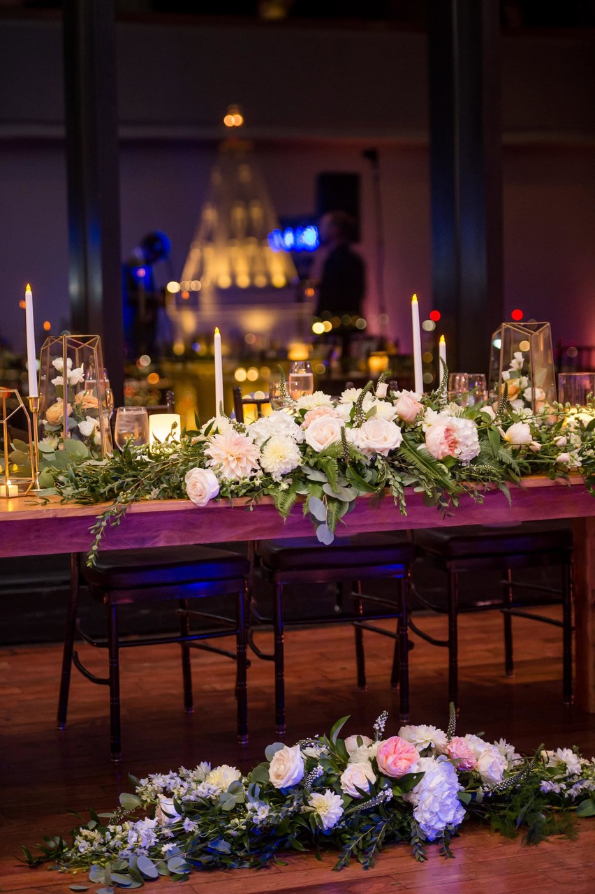 Sweetheart table setup with floral and candle décor