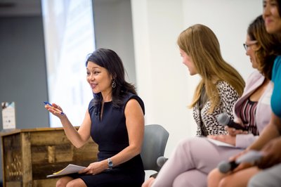 Panel speaker engaging audience at Boston women's event