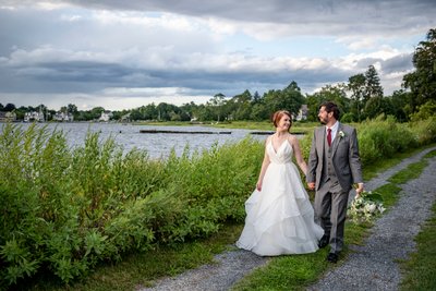 Bride and groom walking by water Blithewold Mansion wedding