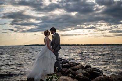 Bride and groom on rocks Blithewold Mansion wedding waterfront