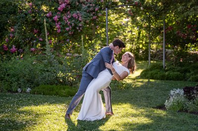 Groom dipping bride Blithewold Mansion wedding garden