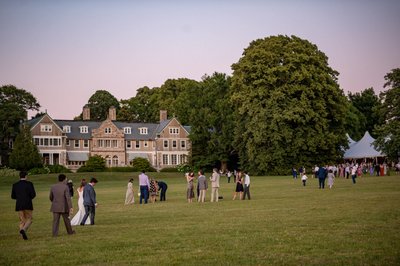 Guests on lawn at dusk Blithewold Mansion wedding venue