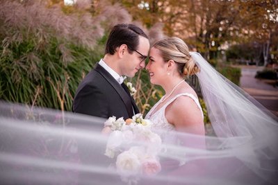 Wedding portrait with a sweeping veil outside The Liberty Hotel in Boston.