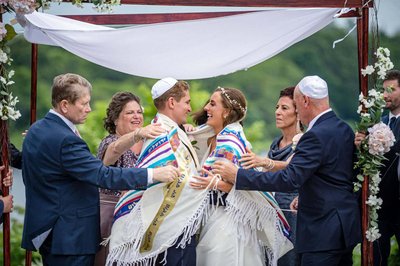 Jewish couple laughing during their ceremony at the Plimoth Patuxet Museum.