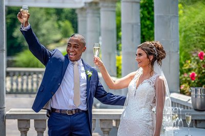 Happy wedding couple raise a toast after their ceremony at Grand View in Mendon.