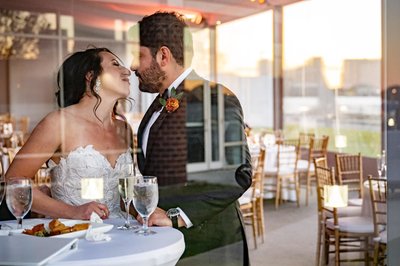 Couple and reflections at the Hyatt Regency Boston Harbor.