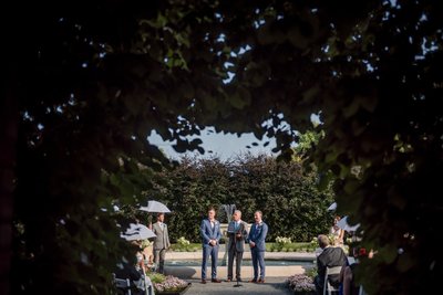 Elm Bank wedding ceremony framed by foliage