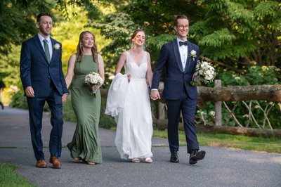 Bride and groom walking with wedding party at Elm Bank