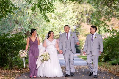 Intimate wedding party walking the main garden path at Elm Bank