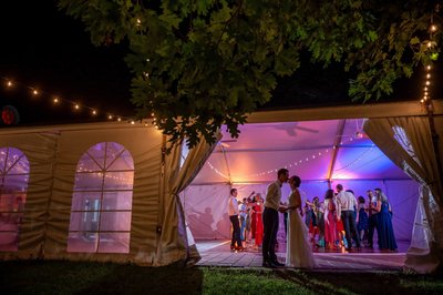 Colorful outdoor tent reception glowing at Elm Bank weddings