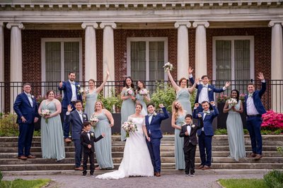 Wedding party celebrating outside the mansion at Elm Bank weddings