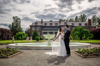 Bride and groom by the reflecting pool at Elm Bank weddings