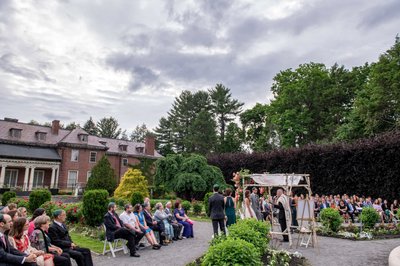 Outdoor wedding ceremony with Elm Bank mansion backdrop