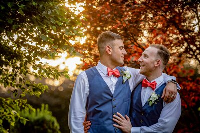 Newlyweds at sunset with fall colors at Elm Bank wedding