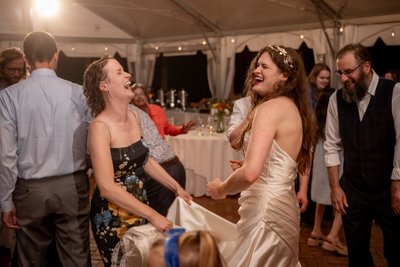 Bride and sister laughing at the Long Hill wedding reception